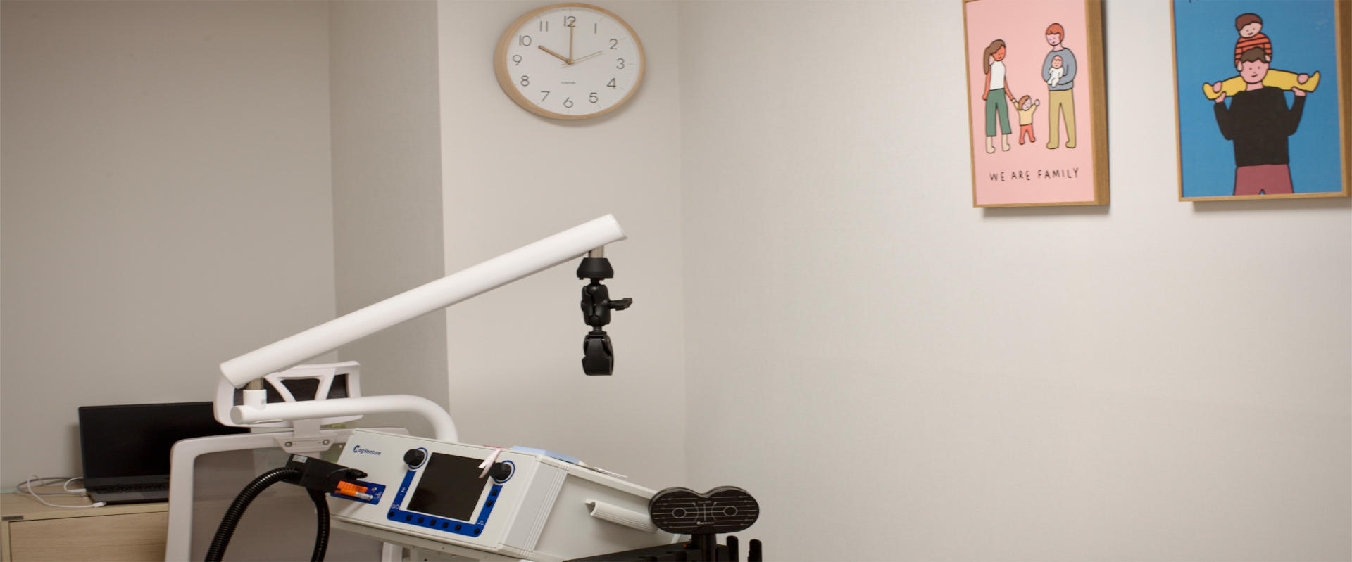 MeRT equipment in a treatment room with clock and framed pictures on the wall