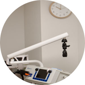 MeRT equipment in a treatment room with clock and framed pictures on the wall